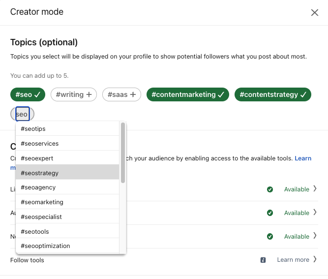 Screenshot of LinkedIn creator hub settings and the optional ability to select topics to add or remove from your profile. Selected hashtags are highlighted in green and unselected hashtags are white. A dropdown appears to show additional topics to select as you type a new topic.