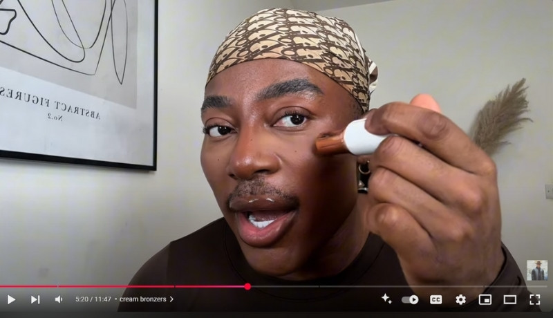 Gary Thompson applies cream bronzer in makeup tutorial on YouTube.