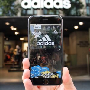 An Adidas Snapchat Geofilter overlaid on a phone screen outside the Oxford Street store.