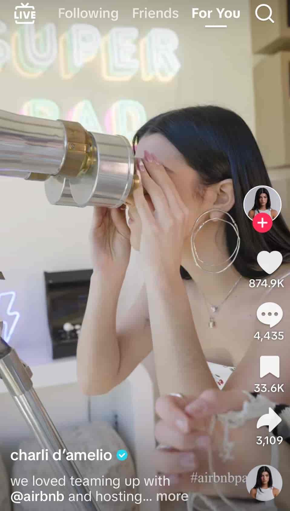 A screenshot shows a TikTok video collaboration between Charli D’Amelio and Airbnb
