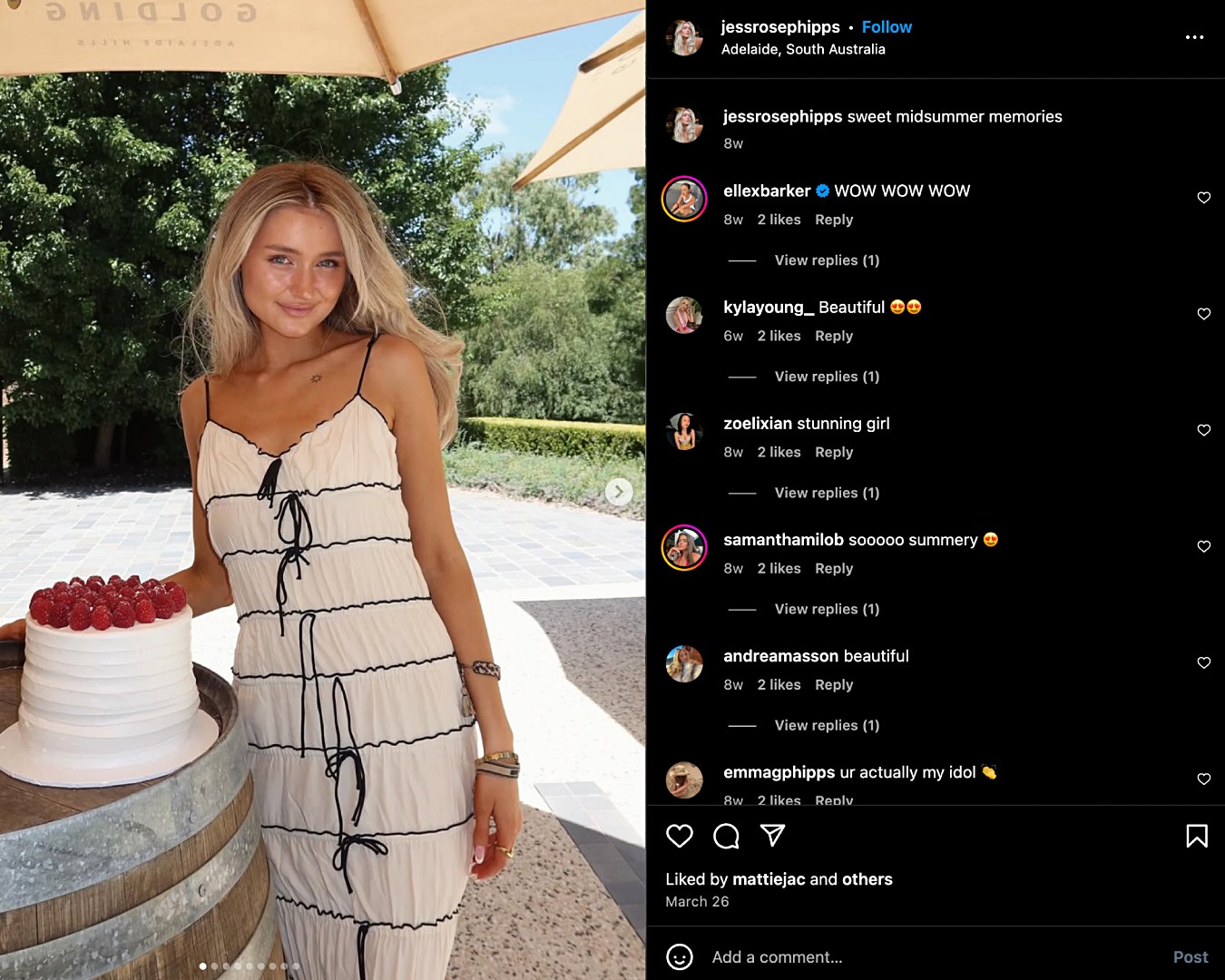Instagram screenshot of Jessica Rose Phipps posing with a white cake topped with raspberries while wearing a flowing white dress