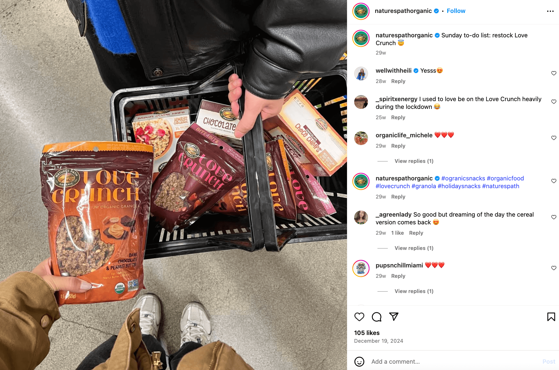 Instagram post from Nature's Path Organic featuring one person holding a grocery basket filled with the brand's products and another person holding one package with a comment section where the brand adds a few hashtags