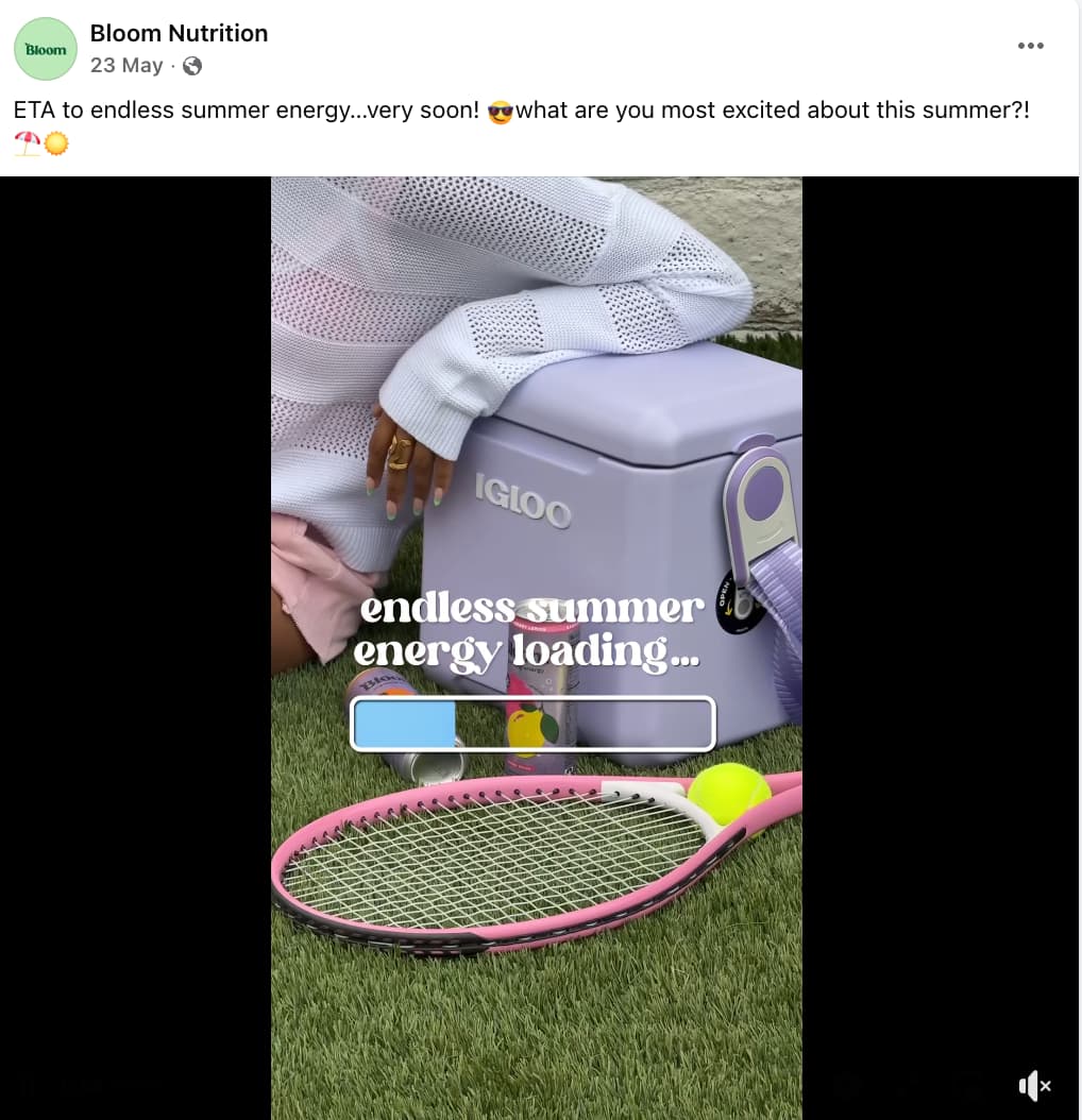 OLIPOP Facebook post showing a person resting their hand on an Igloo ice box and a tennis racket with a ball resting on the grass next to the box and a text overlay with a loading icon that reads "endless summer energy loading..."