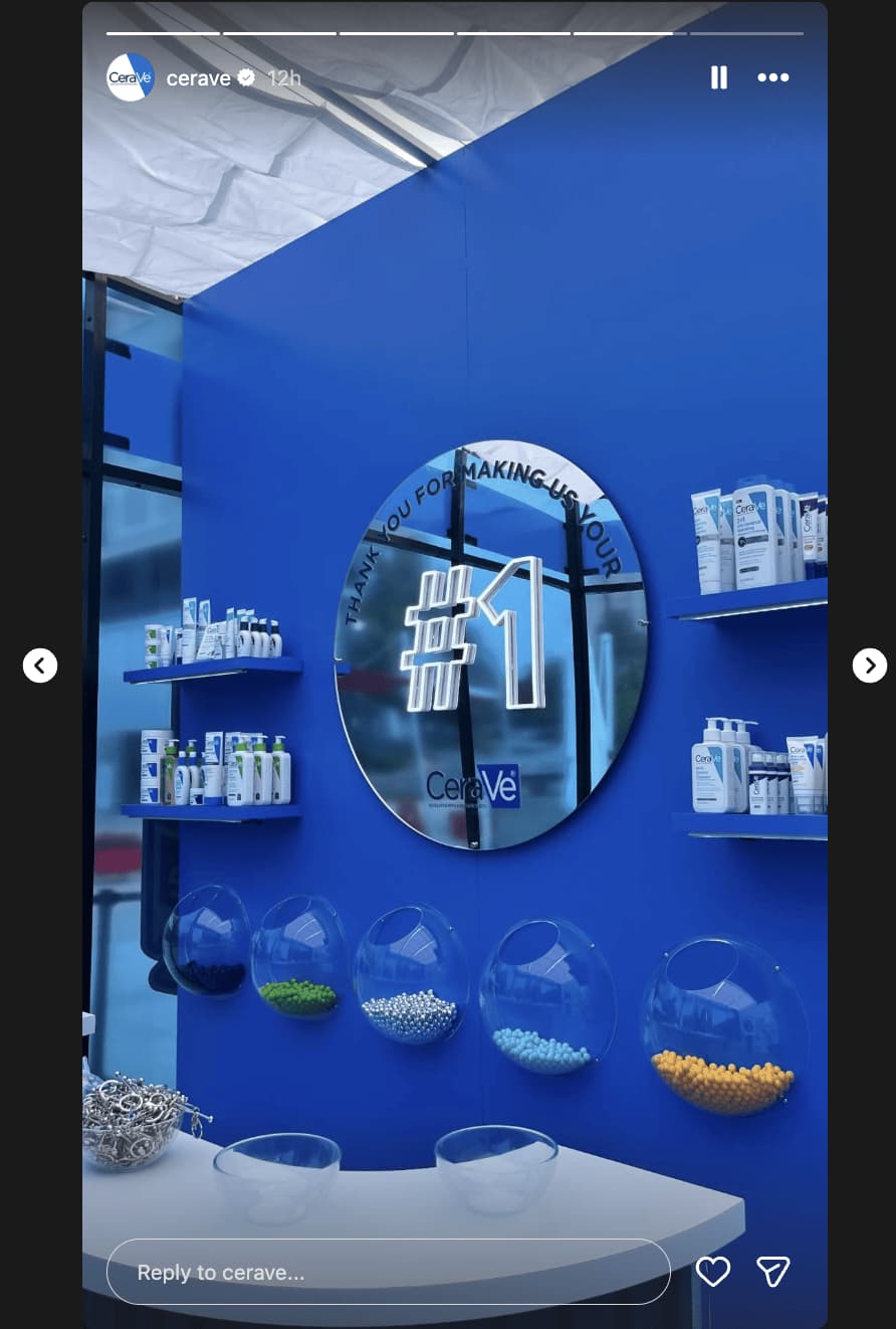 Event setup from CeraVe showing a mirror against a blue background and several CeraVe products on display next to the mirror