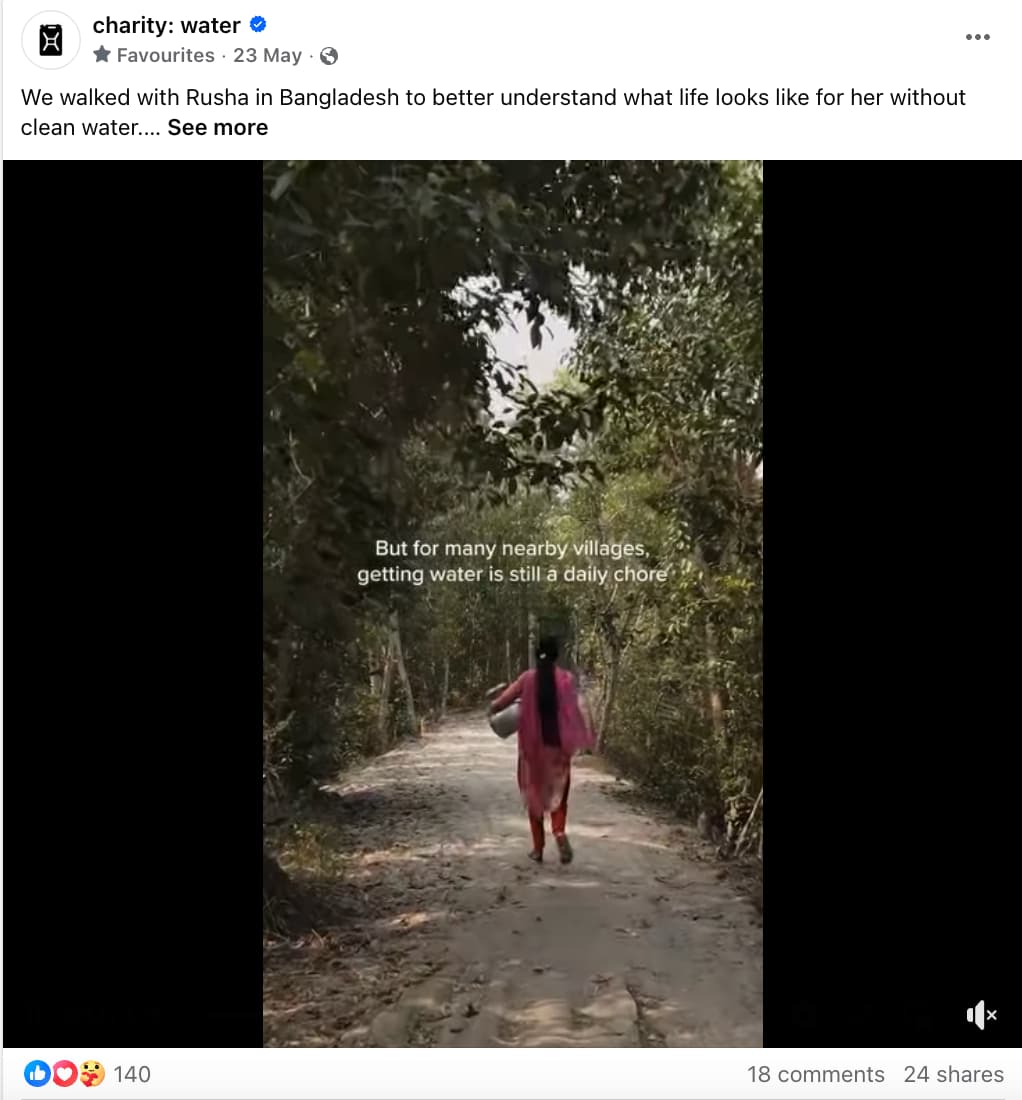 Charity Water Facebook post showing a girl carrying a pot on her side walking on a path lined with trees and text overlay that reads "but for many nearby villages, getting water is still a daily chore."