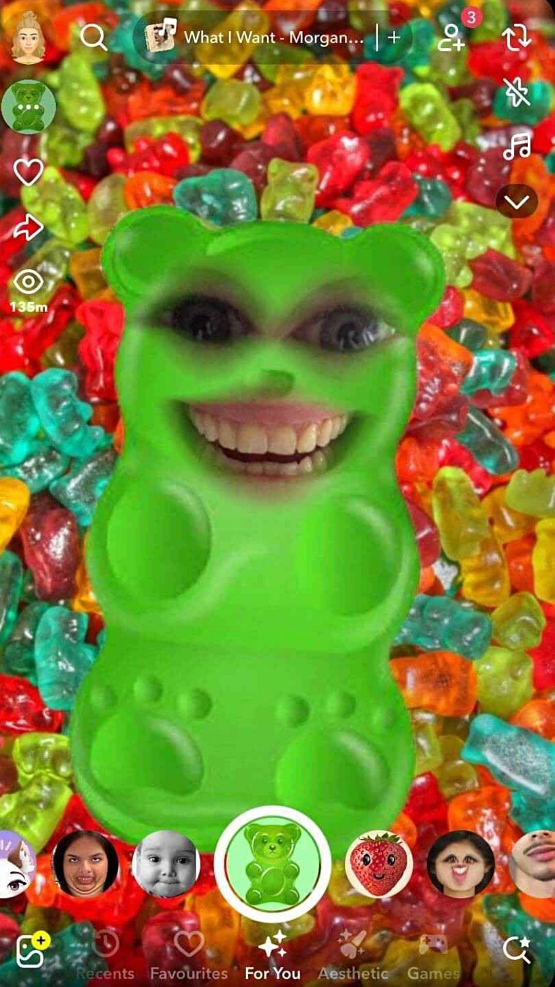 Green gummy bear Snapchat Lens with human eyes and a smiling mouth on a colorful gummy background