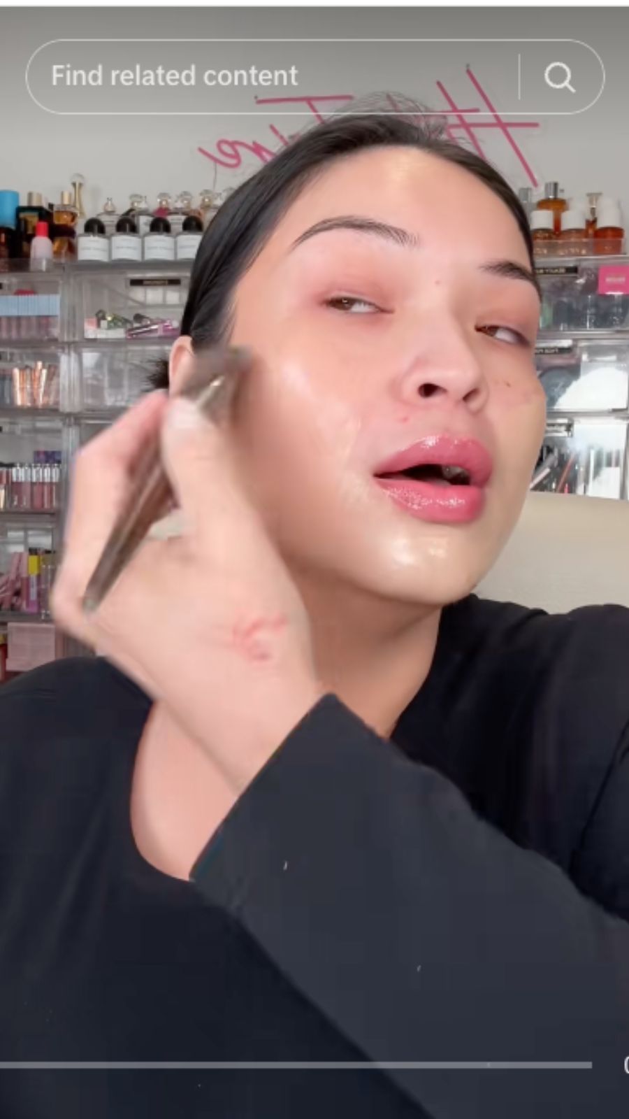 A TikTok content creator applying makeup in a product review.