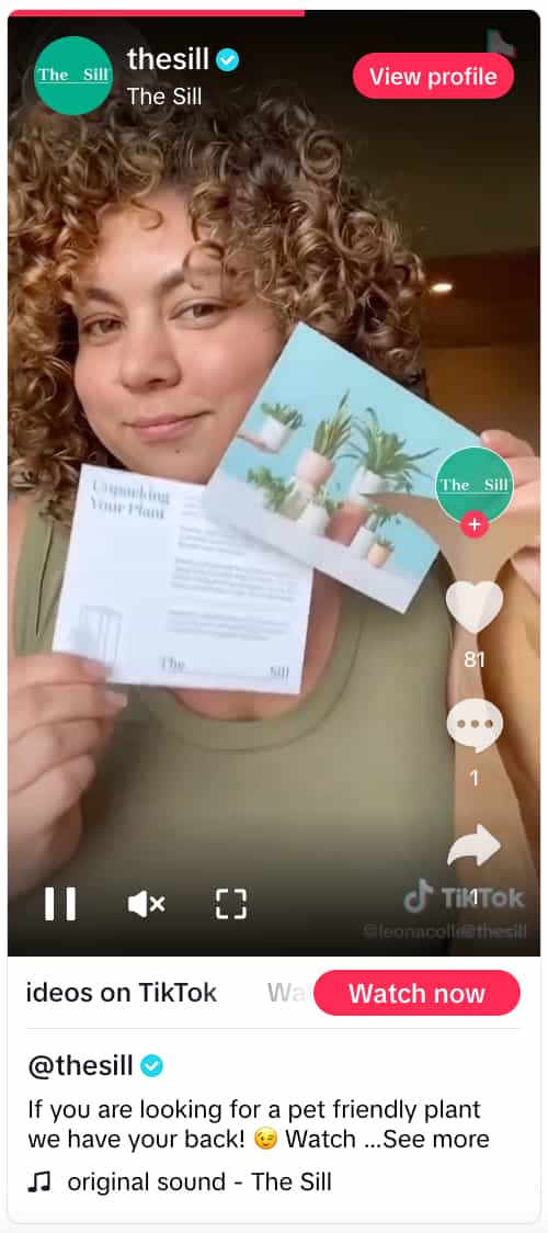 TikTok video from The Sill showing a person holding up two marketing inserts from the brand