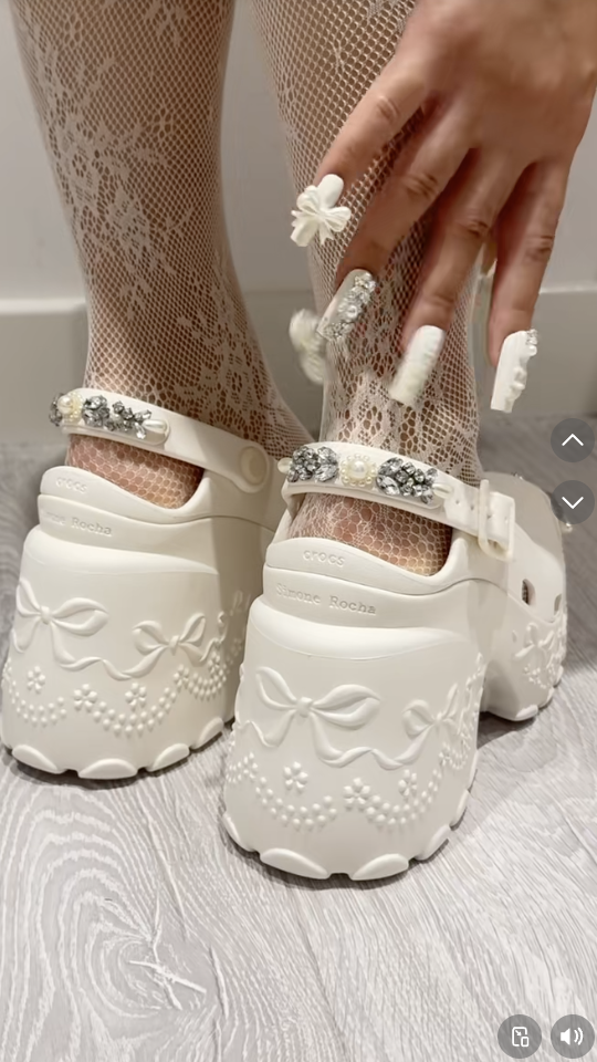 A Crocs TikTok of a person showing a custom manicure that matches their Crocs