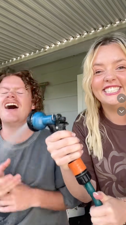 A TikTok video shows Bridey spraying her partner, Michael, with a garden hose