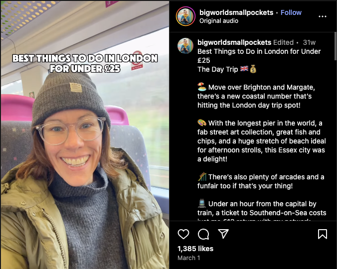 A woman smiling on a UK train wearing glasses and a beanie, filming a travel vlog titled “Best Things to Do in London for Under £25.”