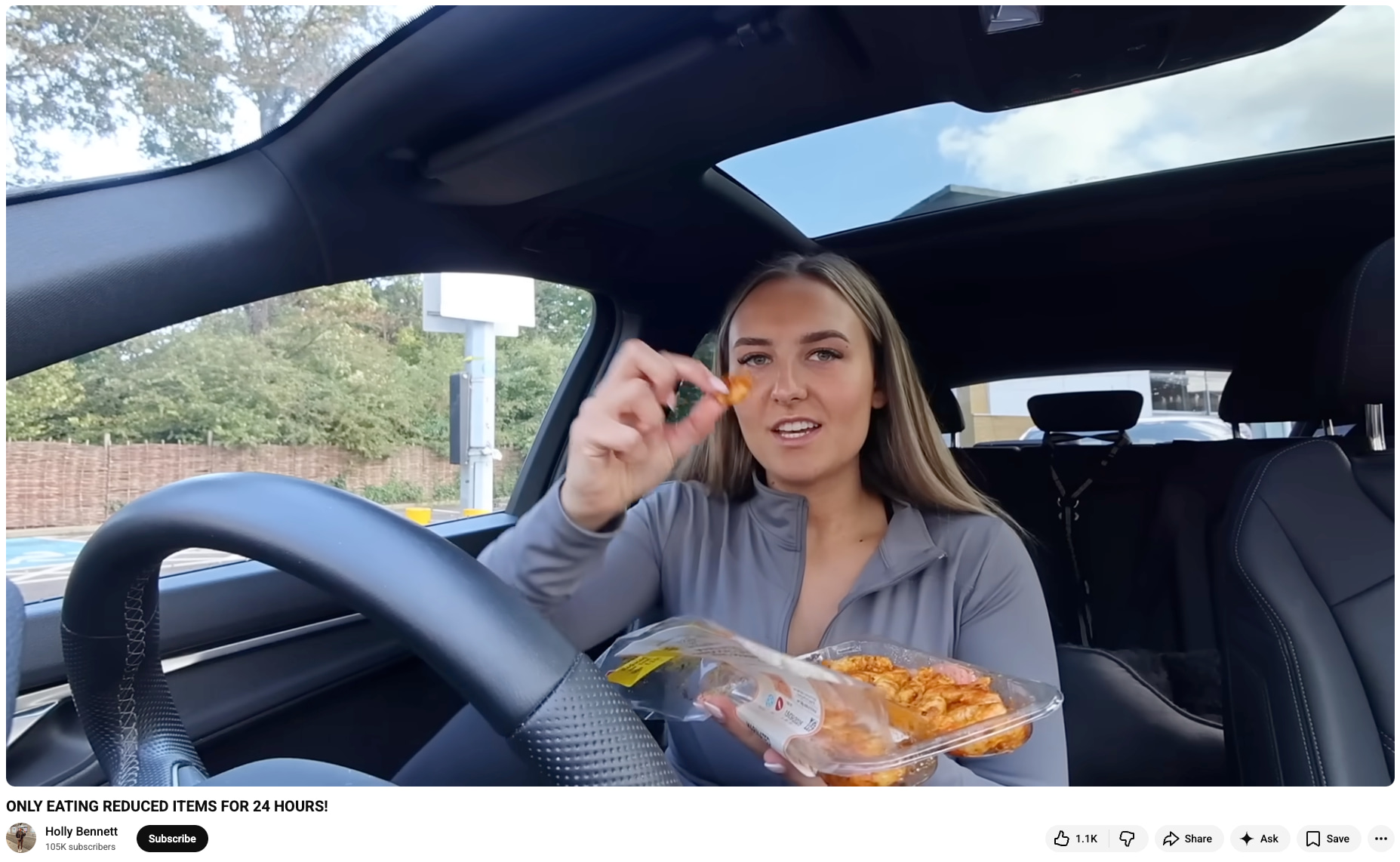 Holly Bennett sits in her car eating reduced-price food for her challenge video, ONLY EATING REDUCED ITEMS FOR 24 HOURS! (Source: YouTube)