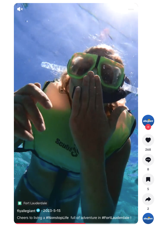 A customer blowing a kiss while diving into the ocean