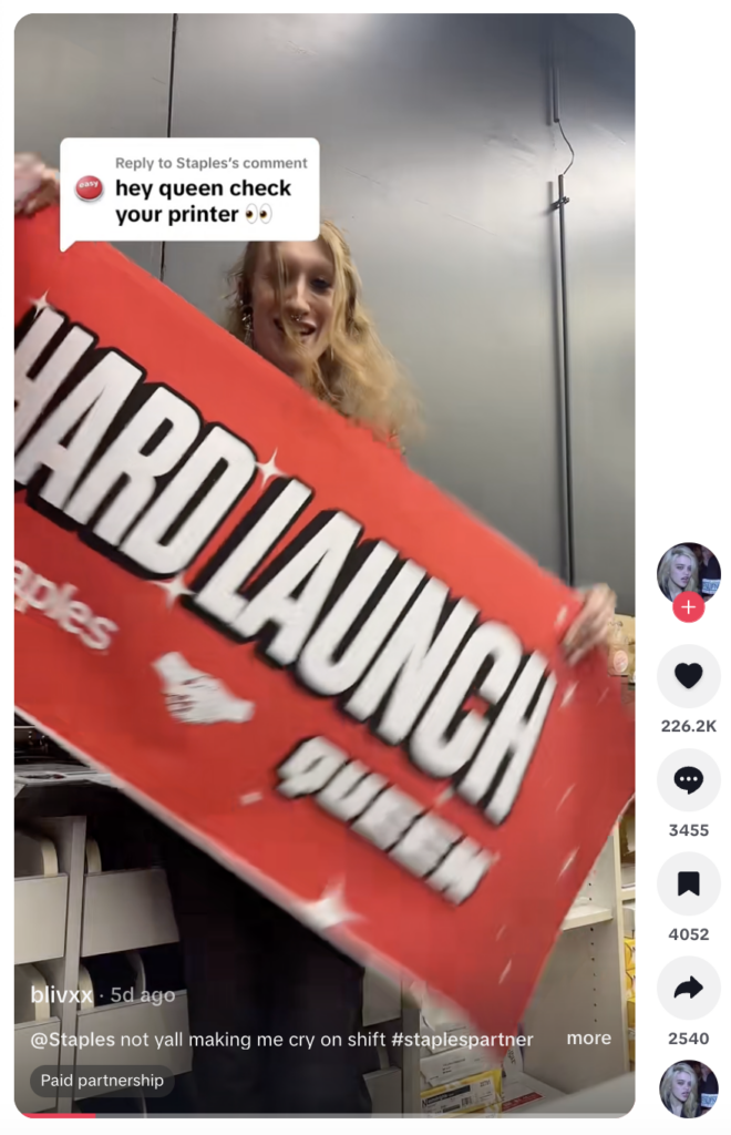 A TikTok video from Oblivion holding a large banner that reads Hard Launch, Staples and Queen. The video is announcing the official brand creator partnership.