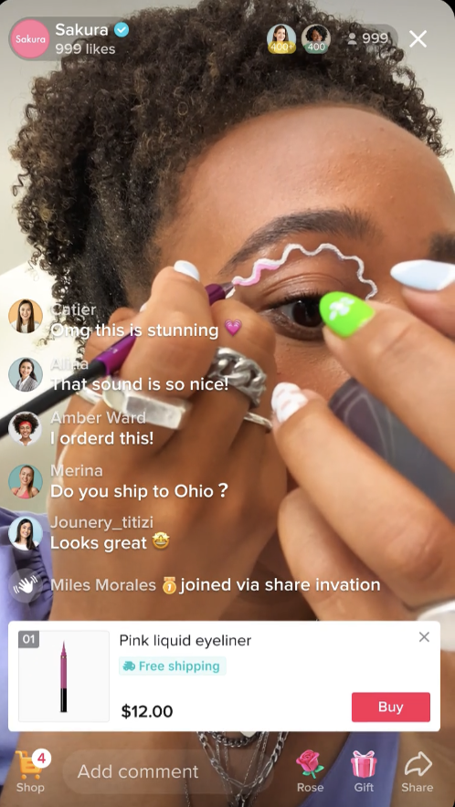 TikTok Live broadcast from Sakura showing a woman applying eyeliner in front of the camera and a product link displaying at the bottom of the screen