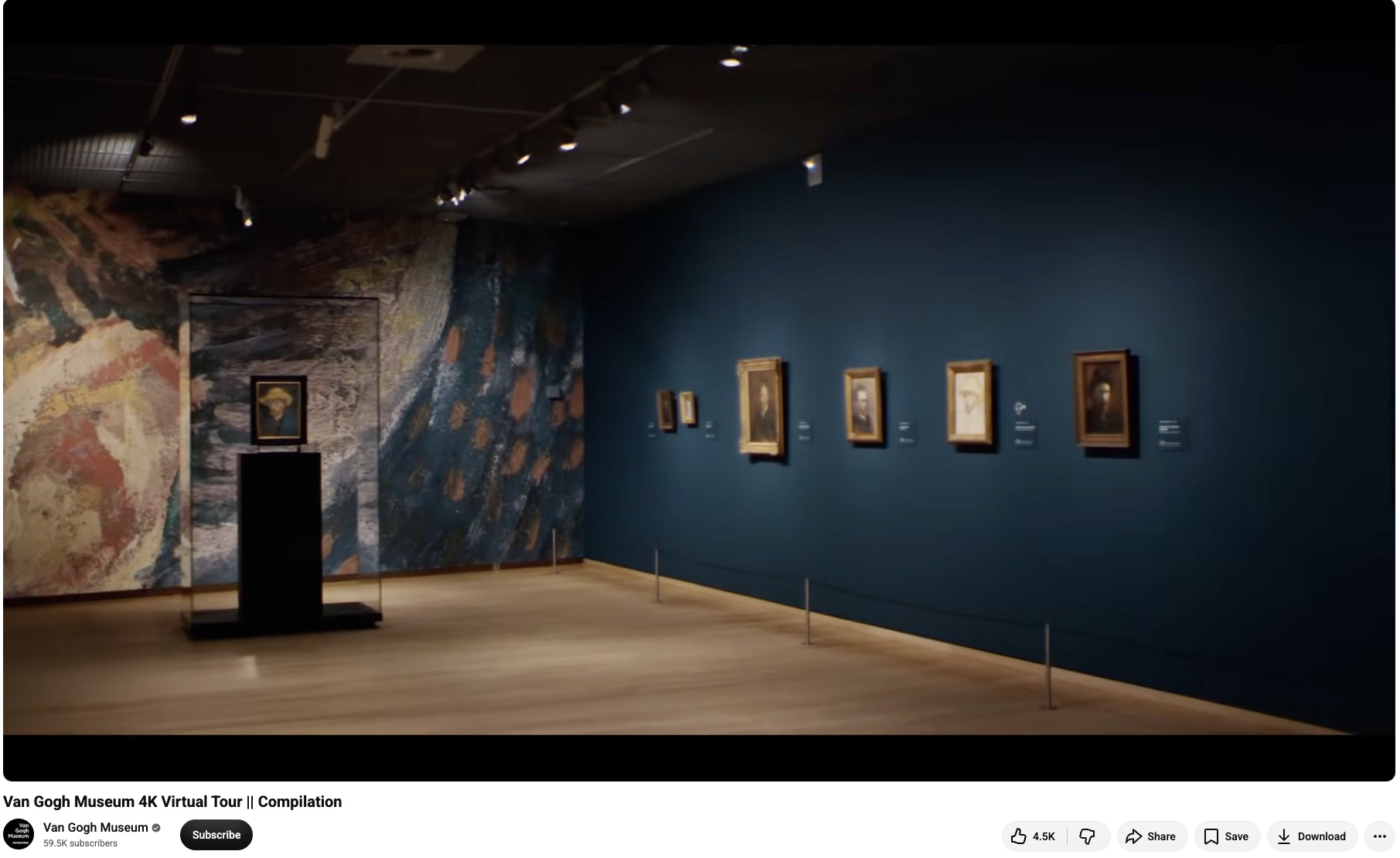 Dimly lit gallery in the Van Gogh Museum displaying framed self-portraits and drawings along a deep blue wall.