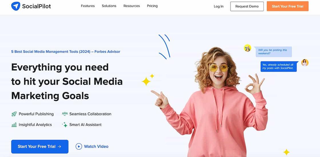 socialpilot homepage with a woman wearing a pink hoodie making an ok sign with one hand and another hand pointing at text that reads everything you need to hit your social media marketing goals