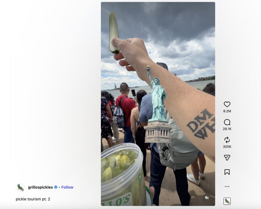 An image form the Grillo's Pickles page of people showing the Statue of Liberty to a pickle.