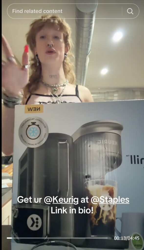 A screenshot of a TikTok in which the Staples Baddie showcases a Keurig machine you can buy at Staples